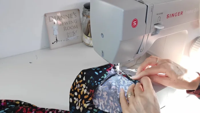 Insert Elastic into Sleeves: Measure and thread elastic through the sleeve openings, joining the ends and stitching securely. Close the opening.