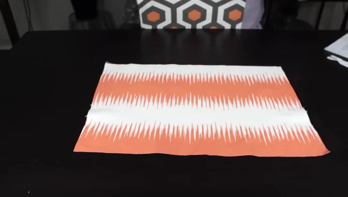 Construct the zipper pocket: Sew the main fabric zipper pocket piece to the lining fabric inside body piece, creating a Y-shaped opening to turn right side out. Attach zipper.