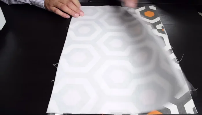 Sew the side pieces of the outer bag together, leaving the top open. Create a corner pleat at the bottom.