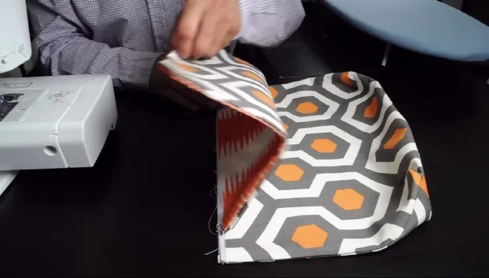 Attach the flap to the bag using zigzag stitch; create bar tacks for support.