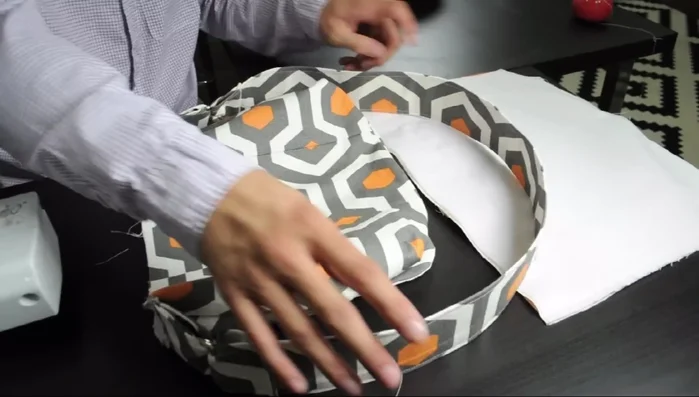 Insert the outer bag into the lining, aligning edges and pinning. Sew together around the opening, removing pins as you go. Turn right side out.