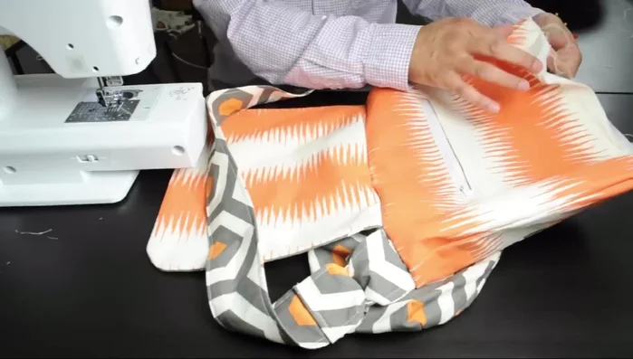 Close the opening using an invisible stitch. Iron and top-stitch the top of the bag and flap.