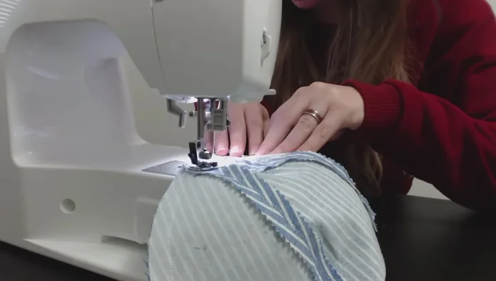 Join the two cap halves together, sewing along the top seam. Check the fit and adjust if necessary by removing and resewing the back seam for proper fit.