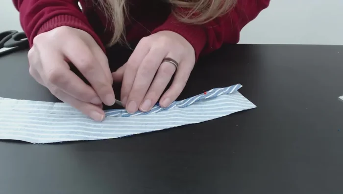 Attach the facing to the inside of the cap, making sure to create clean edges and secure the facing in place with stitching.