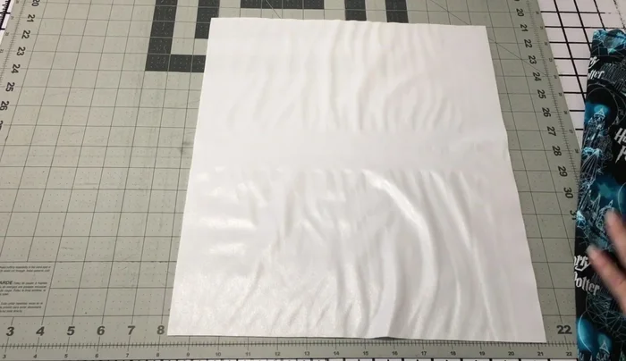 Create the front panel: Lay PUL (shiny side up), zipper (right side up), and outer fabric (print facing you, right side to right side of zipper) on top. Clip together instead of pinning.