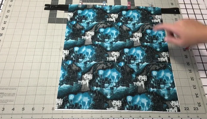 Sew the zipper to the PUL and outer fabric: Use a zipper foot and sew down the right side of the zipper, backstitching at the beginning and end.