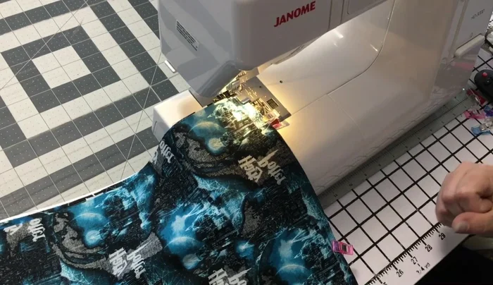 Sew the back panel to the zipper: Using the zipper foot, sew the back panel to the zipper, matching the seams and backstitching at the beginning and end. Topstitch the back panel.