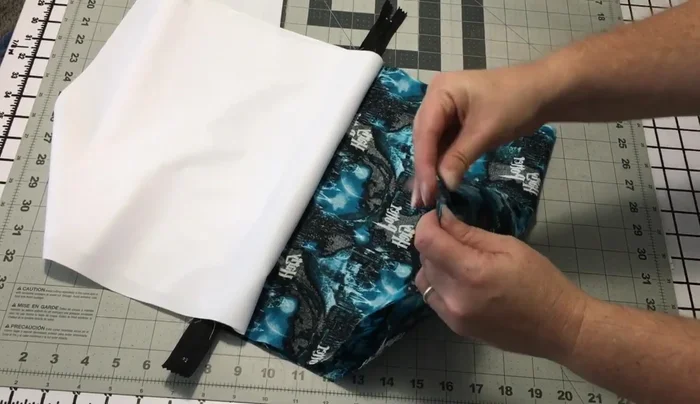 Sew side seams: Pin/clip the outer fabric pieces together, matching the seams. Sew along the sides, leaving a gap for turning. Use chain piecing to save thread. Remember to leave a hole in the PUL for turning.