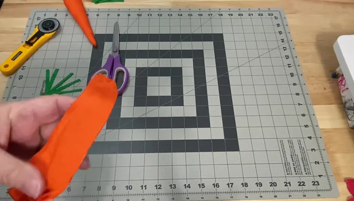 Turn and stuff carrots: Carefully turn the sewn carrot pieces right side out using hemostats or a turning tool. Stuff with fiberfill.