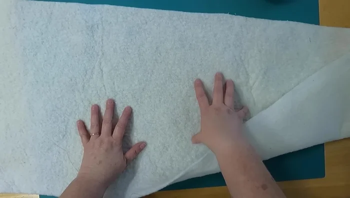 Prepare the batting: Fold the batting in half lengthwise and finger press the middle crease. This helps to center your fabric strips.