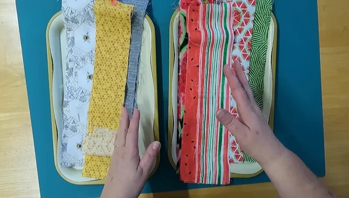 Plan your fabric placement: Arrange your fabric strips on both sides of the folded batting, considering color and pattern combinations. You can arrange randomly or create a specific pattern.