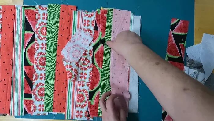 Add end pieces: To finish the ends, add angled fabric strips that extend the length of each end. Ensure they will cover the raw edges on both sides of the runner when folded.