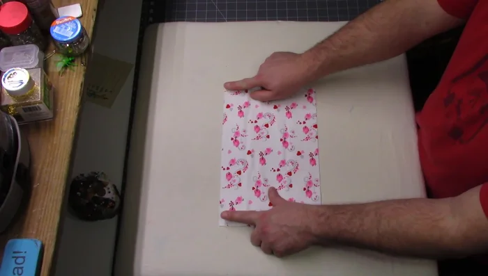 Prepare the lining: Fold over 1/2 inch of the 12.5" side of the smaller fabric piece (8" high), press, and sew a 1/4" seam allowance.