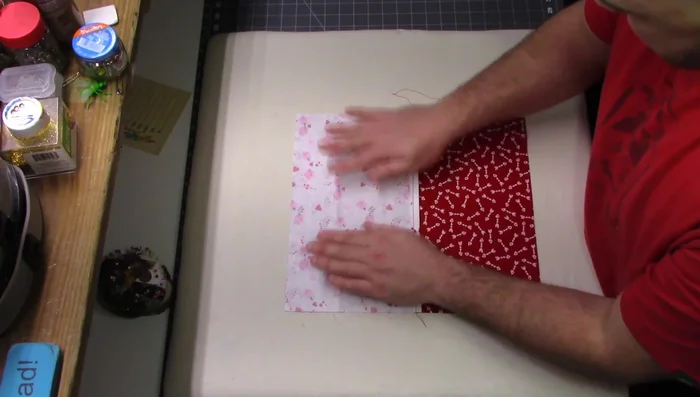 Attach the lining to the main fabric: Match the raw edges of the lining and the 12.5" side of the larger fabric (14" tall), and sew a 1/4" seam allowance.