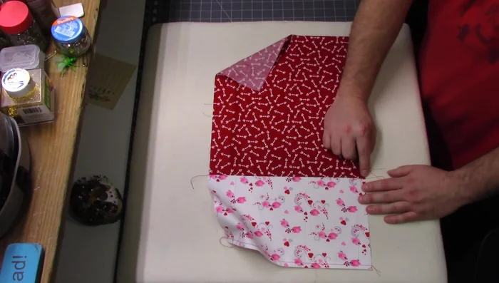 Press and tack the seam: Press the seam towards the larger fabric piece and sew a 1/8" seam to secure it.