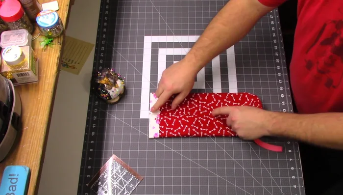 Attach the ribbon: Measure 4 inches down from the top seam, pin the ribbon, and sew it down using several passes for added security.