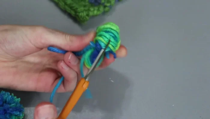 Fluff the pom-pom and trim any stray pieces.