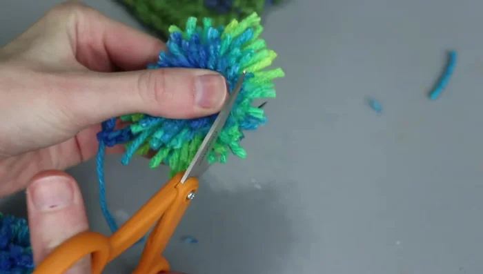 Fluff the pom-pom and trim any stray pieces.
