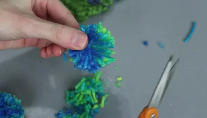 Fluff the pom-pom and trim any stray pieces.