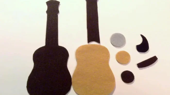 Glue the seven white strips and four small white circles onto the dark brown piece.