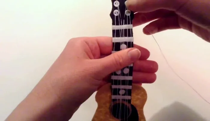 To secure the strings, stitch along each white strip with white thread to keep them in place.