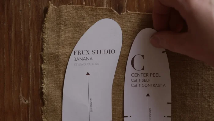 Trace patterns onto fabric: Arrange pattern pieces with the grain line on the straight grain of the fabric, parallel to the selvage.