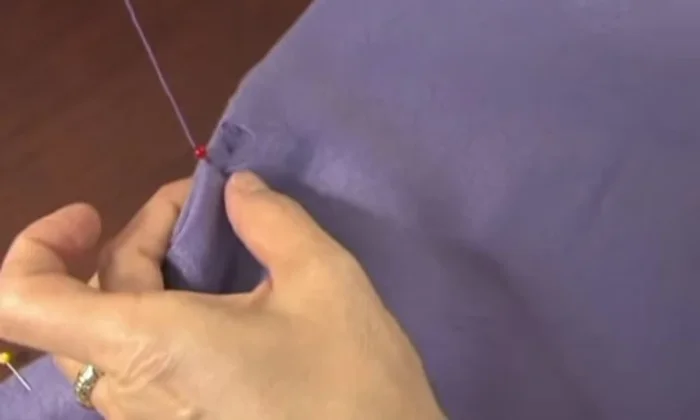Blanket stitch around the edges. Continue the blanket stitch around all four sides of the fabric.