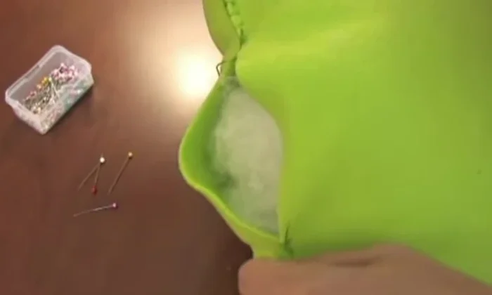 Pin and stitch the opening. Pin the opening closed and complete the blanket stitch to seal the pillow.