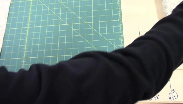 Iron the long binding strip in half, ensuring raw edges are even.