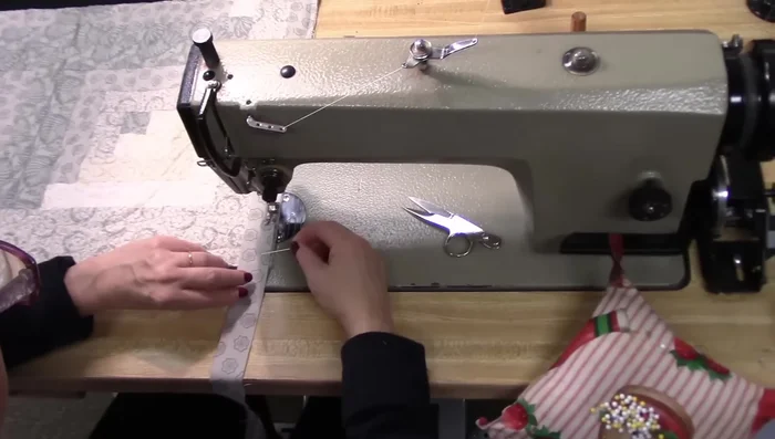 Fold the binding at a 45° angle, aligning raw edges. Finger press and fold down, ensuring the fold and raw edge are on the same line. 