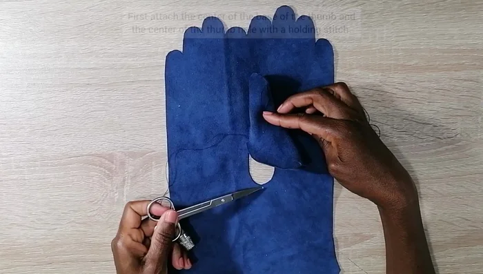 Sew the thumb base onto the thumb hole.