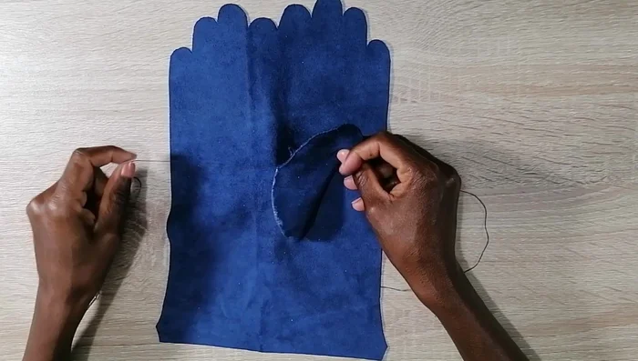 Sew the thumb base onto the thumb hole.