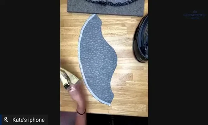 Apply woven knit stay tape to the raw edge of the hem, using an iron to fuse it in place. This adds stability and helps the curve hold its shape.