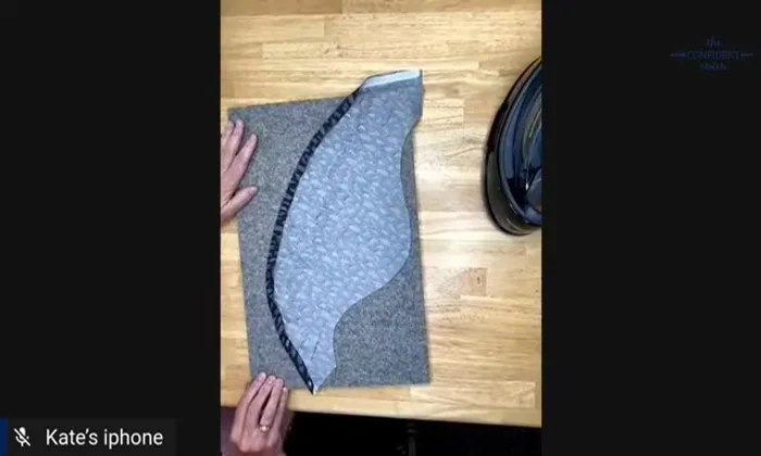 Turn the hem up to the stitched line, pinning it to your ironing surface for easy pressing. Press the hem in place.