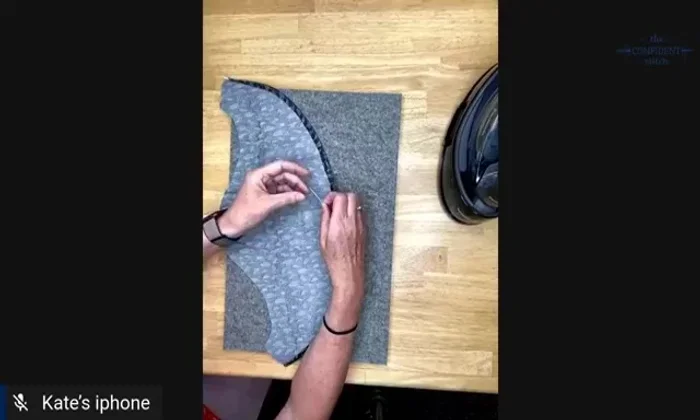 Baste the hem in place using a long running stitch from the wrong side. This secures the hem and provides a clear guide for the final stitch.