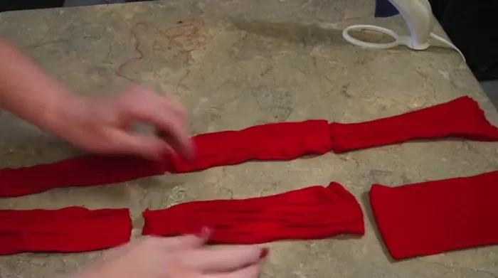 Cut the legs off of a pair of old tights. You should have six pieces.