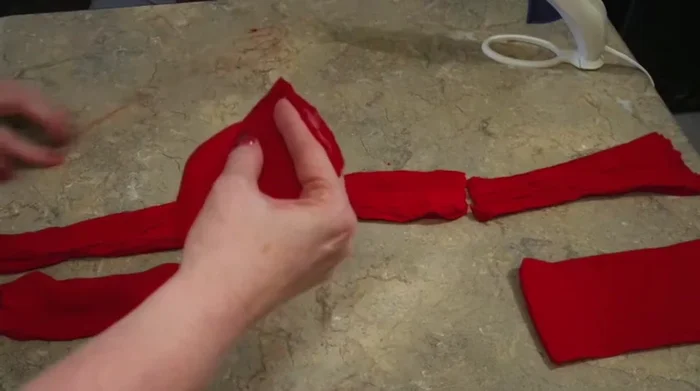 Shape and adjust the apple, squeezing and molding it into a desired shape.