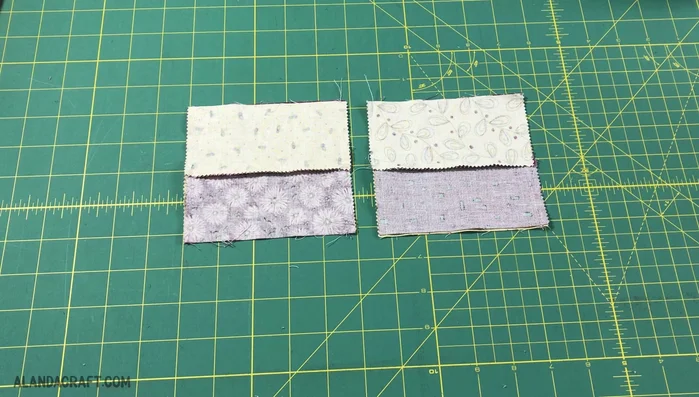 Lay the sewn pieces flat, seams horizontal. Align the 2 1/2 inch mark on your ruler with the center of each piece. Slice through the middle with your rotary cutter.