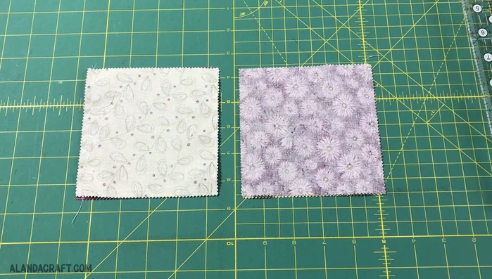 Lay the sewn pairs flat, seams vertical. Use your ruler to align the 2 1/2 inch mark with the center of each piece. Slice through the middle with your rotary cutter.
