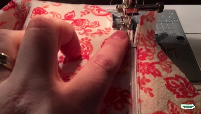 Repeat for the other side. Sew the zipper to the other side of the fabric, ensuring the zipper foot is on the opposite side and sewing in the same direction as the first side.