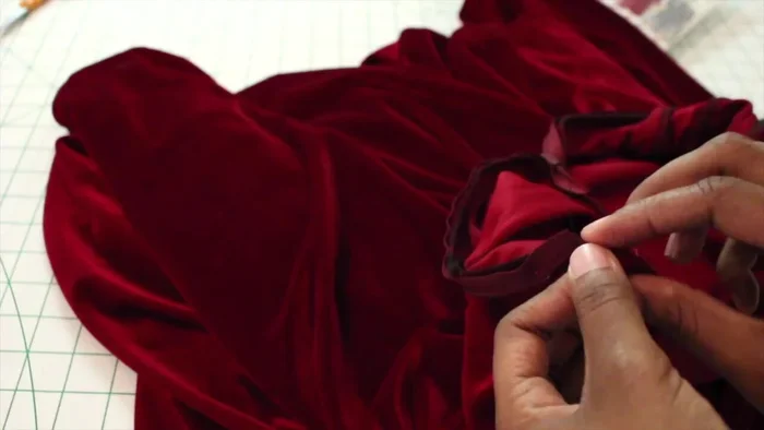 Finish the collar by pressing under 3/8 inch of the raw edge, folding it over the seam allowance, and topstitching in the ditch.