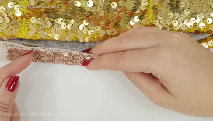 Hem the garment by hand, using a contrasting thread to aid in stitch removal if necessary.