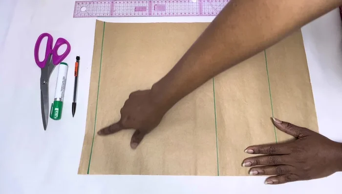 Take measurements (shoulder to bust point, shoulder to waist, neck width, neck depth) and mark them on the pattern paper.