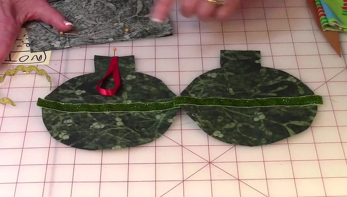 Add ribbon trim to one piece, mark its position on the template, and stitch it on.