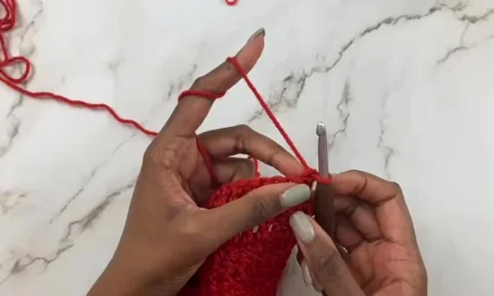 Chain 4, skip 6 stitches, and work another V-stitch in the 7th stitch. Repeat this pattern across the row, using chain 3 between double crochets for center V-stitches.