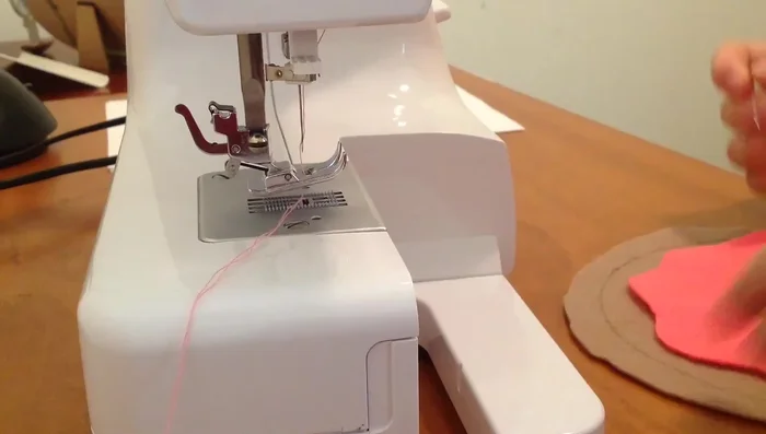 Sew along the edges of the icing and dough base.