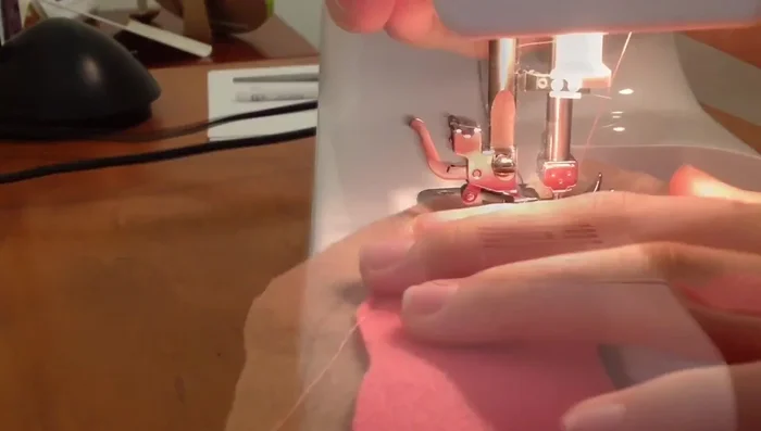 Sew along the edges of the icing and dough base.