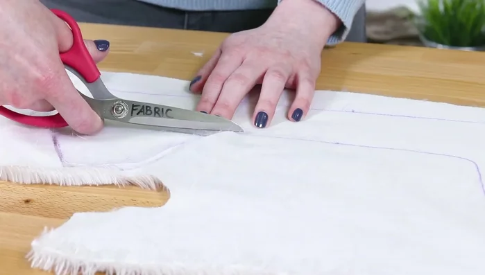 Cut two 1-inch wide by 18-inch long fleece strips for the ties.