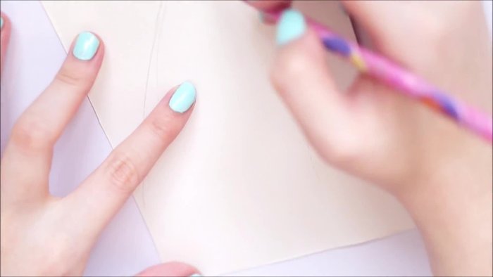 Draw a template on cardboard, marking areas for red, white, and green fabric.