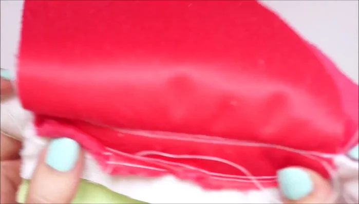 Place the two red fabric pieces right sides together, aligning the stripes. Pin and sew around the template, leaving the bottom open.